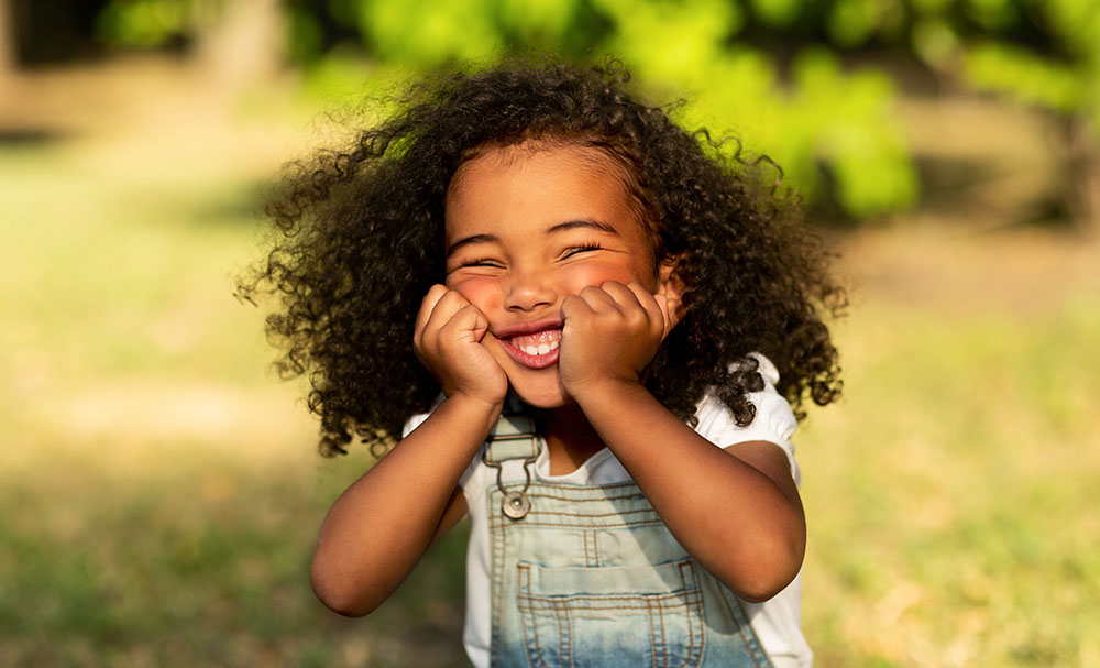 happy young girl out in nature at a Preschool & Daycare Serving New Braunfels, TX