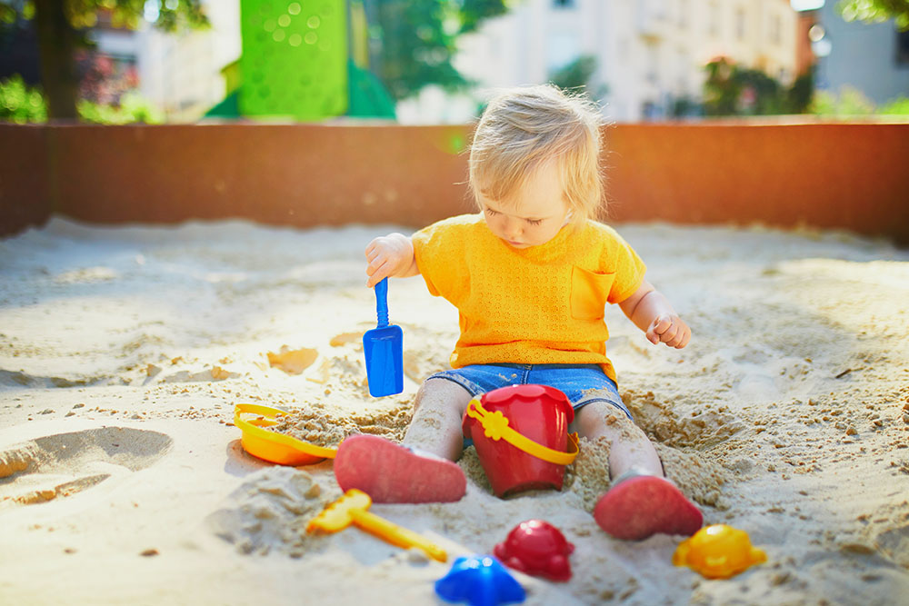 Adorable little girl on playground at a Preschool & Daycare Serving New Braunfels, TX