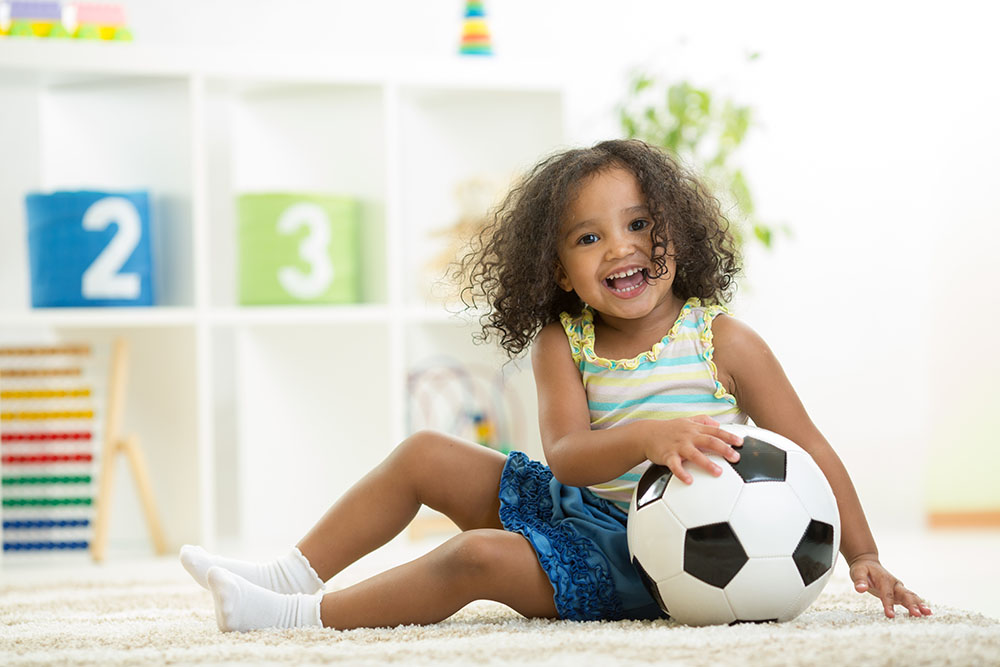 Kid girl playing soccer at a Preschool & Daycare Serving New Braunfels, TX