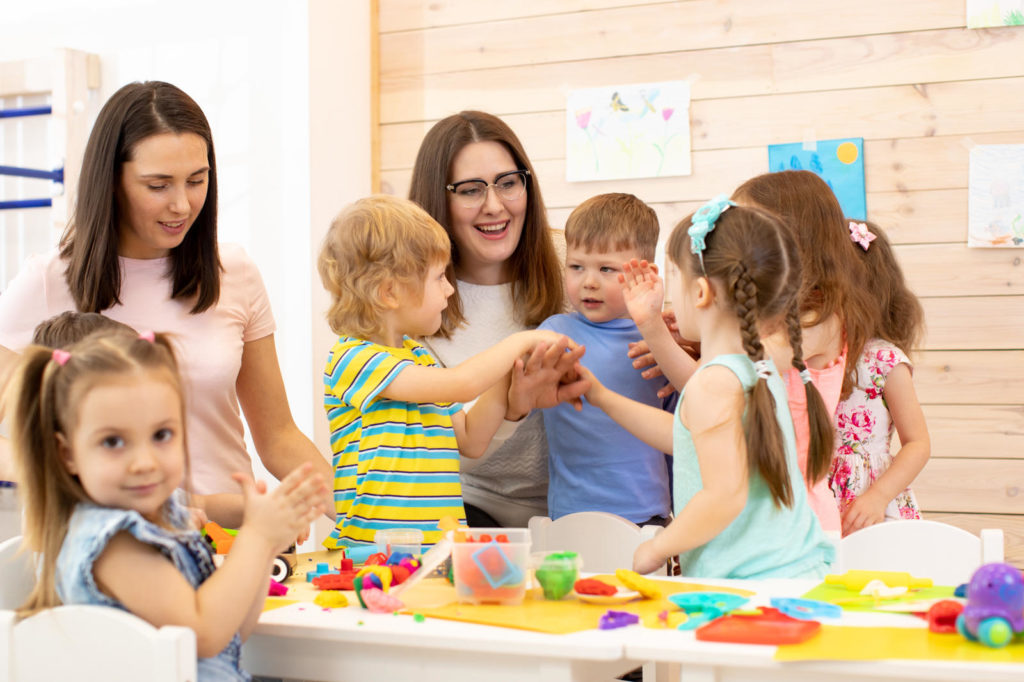 Kindergartener with kids group after lesson in classroom at a Preschool & Daycare Serving New Braunfels, TX