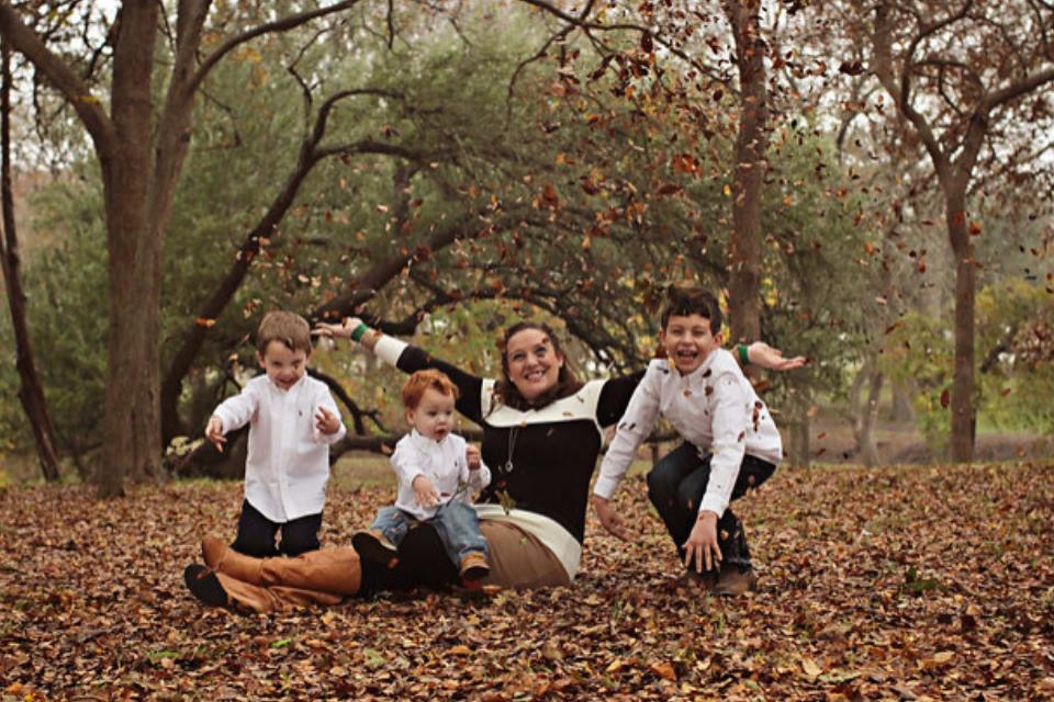 Family playing in leaves at a Preschool & Daycare Serving New Braunfels, TX
